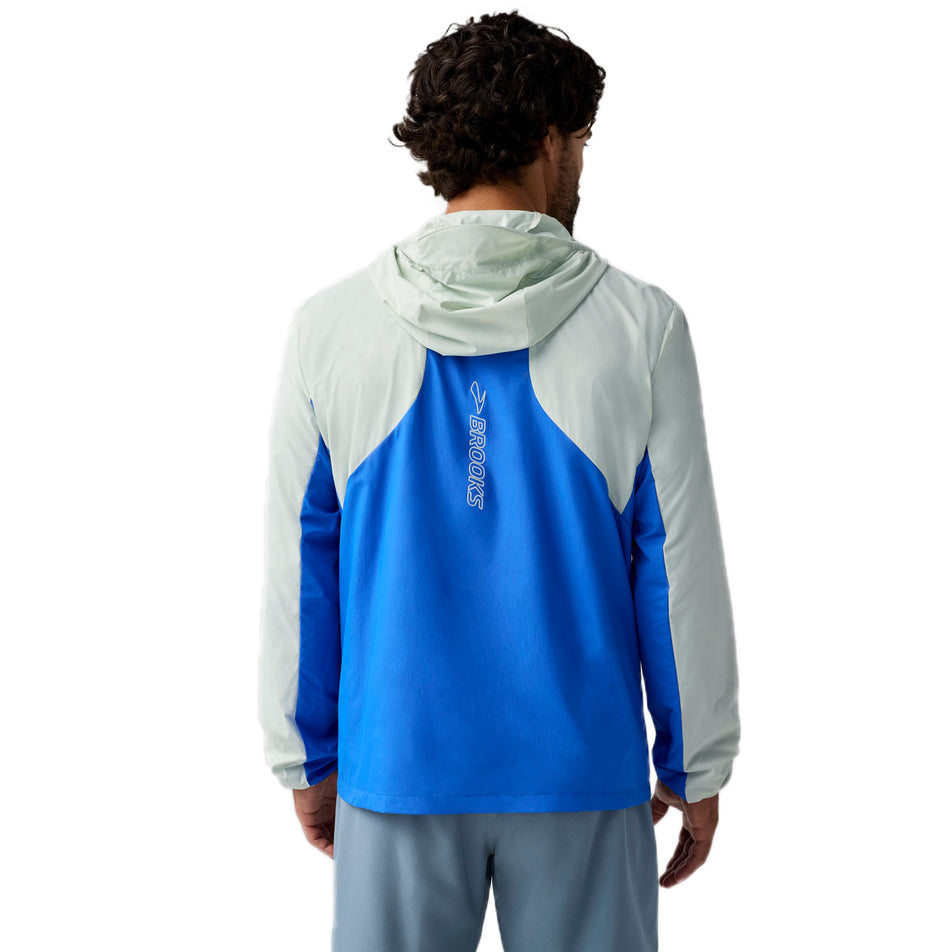 Back view of a model wearing the Brooks Men's Canopy Jacket 2.0 in the Neo Blue/Storm colourway. (8718746484898)