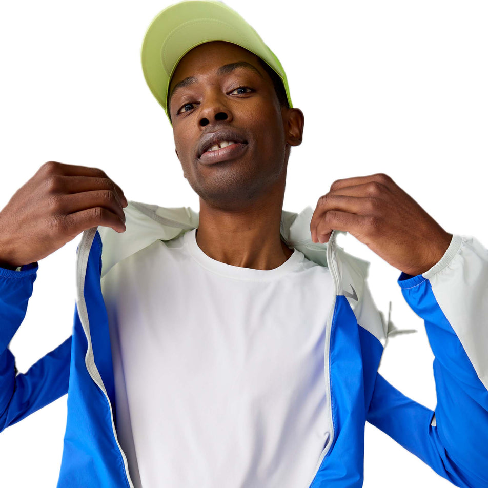 Front view of a model wearing the Brooks Men's Canopy Jacket 2.0 in the Neo Blue/Storm colourway. (8718746484898)