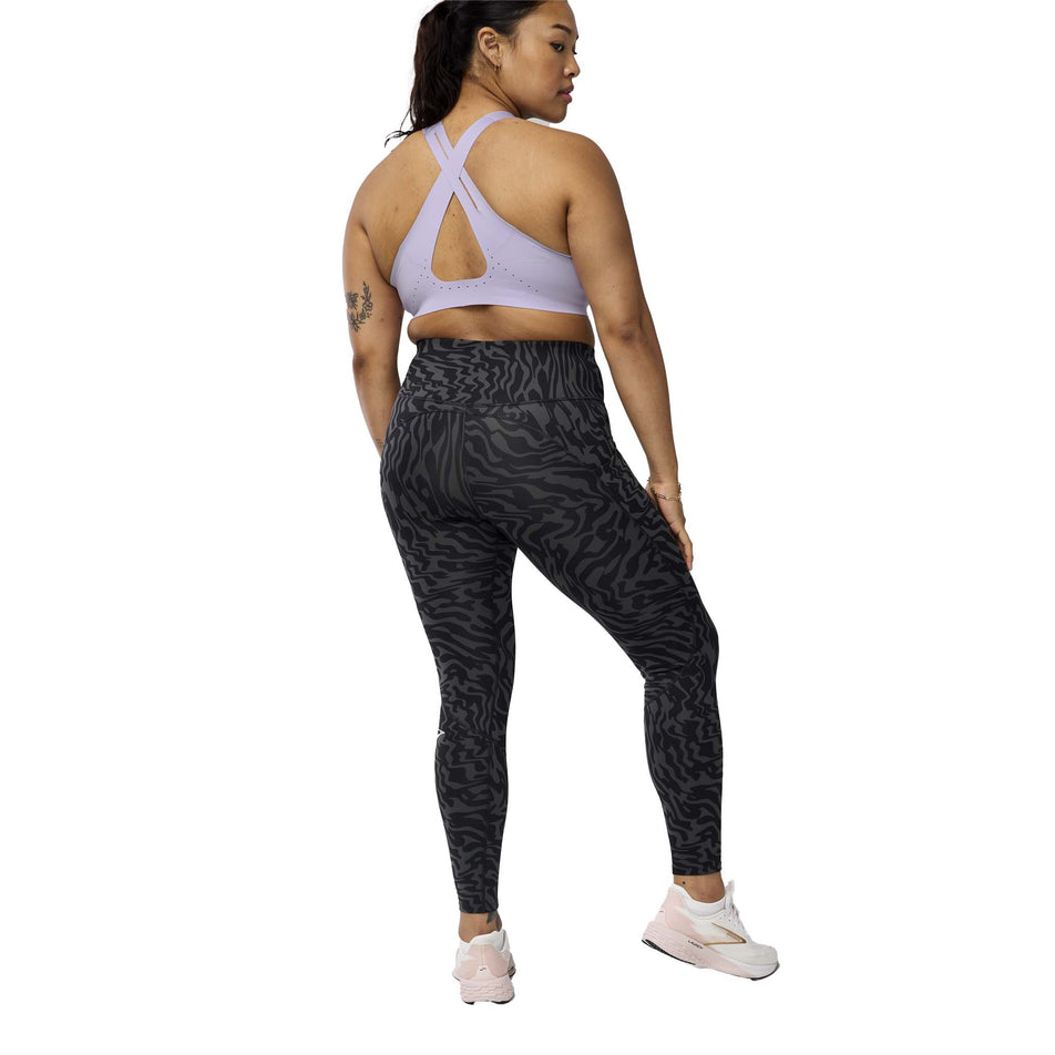 Back view of a model wearing the Brooks Women's Spark Tight in the Obsidian Speedscape colourway. (8575025152162)