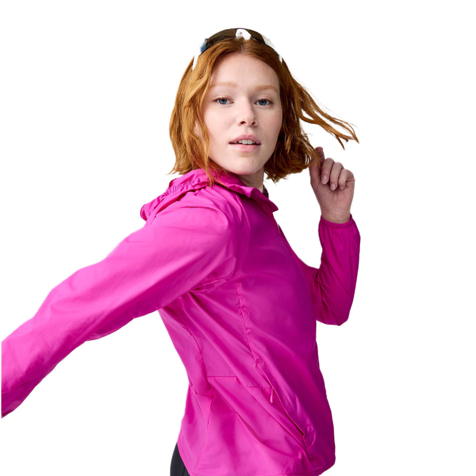 Angled view of a model wearing the Brooks Women's Canopy Jacket 2.0 in the Magenta colourway. (8718875951266)