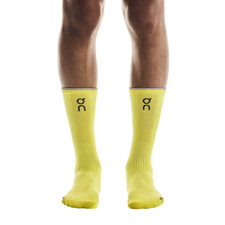 Front view of a model wearing a pair of On Unisex Elite Run Sock High in the Lime colourway. (8717355712674)