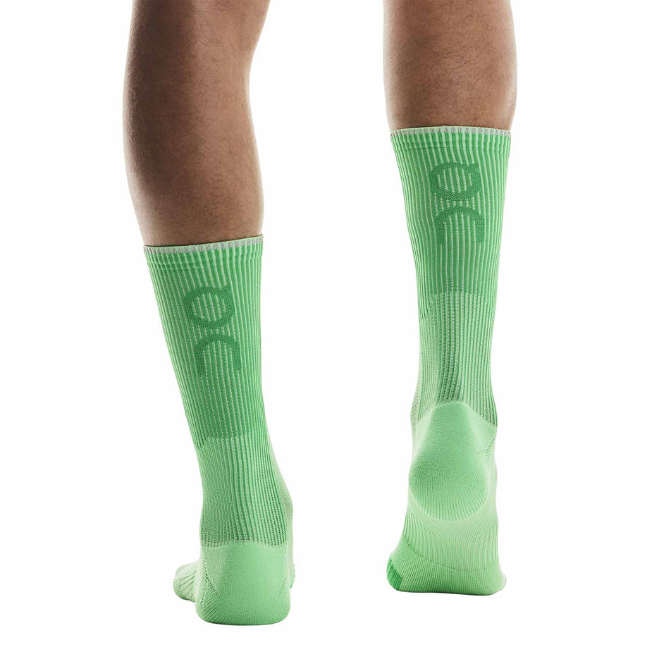 Back view of a model wearing the On Unisex Performance Run Sock High in the Honeydew/Parsley colourway.  (8717316260002)