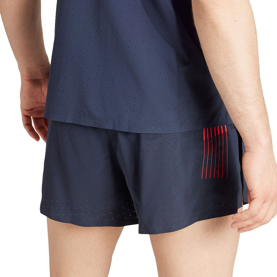 Angled back view of a model wearing a pair of adidas Men's Team GB Adizero Running 3-Inch Split Shorts in the Legend Ink colourway. Model is also wearing an adidas top. (8324054614178)