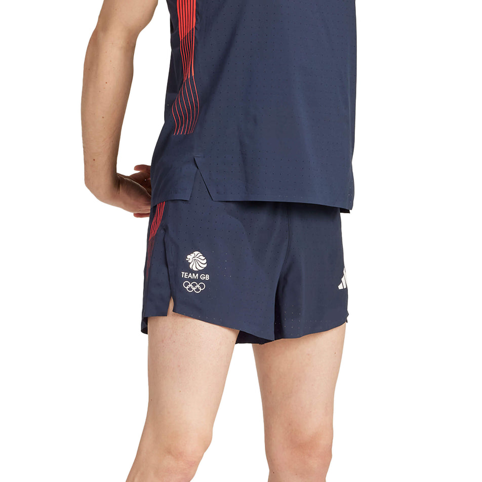 Angled front view of a model wearing a pair of adidas Men's Team GB Adizero Running 3-Inch Split Shorts in the Legend Ink colourway. Model is also wearing an adidas top. (8324054614178)