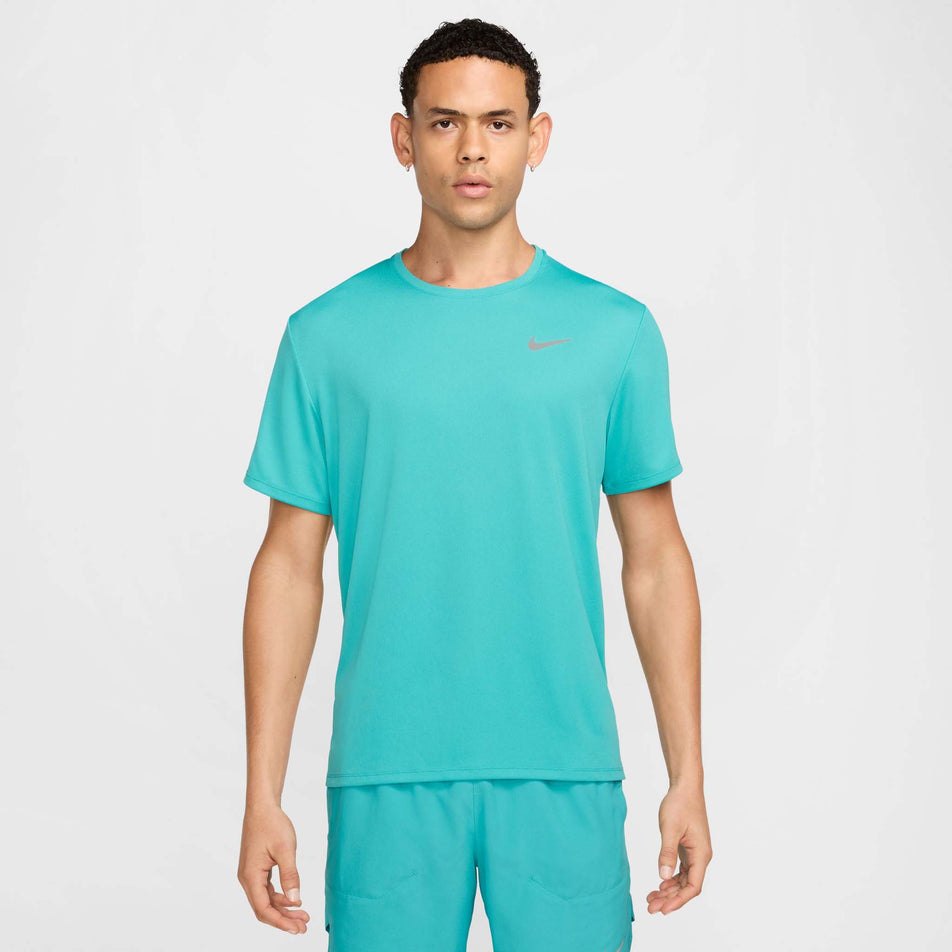 Front view of a model wearing the Nike Men's Miler Dri-FIT UV Short-Sleeve Running Top in the Dusty Cactus/Reflective Silver colourway. (8562855116962)