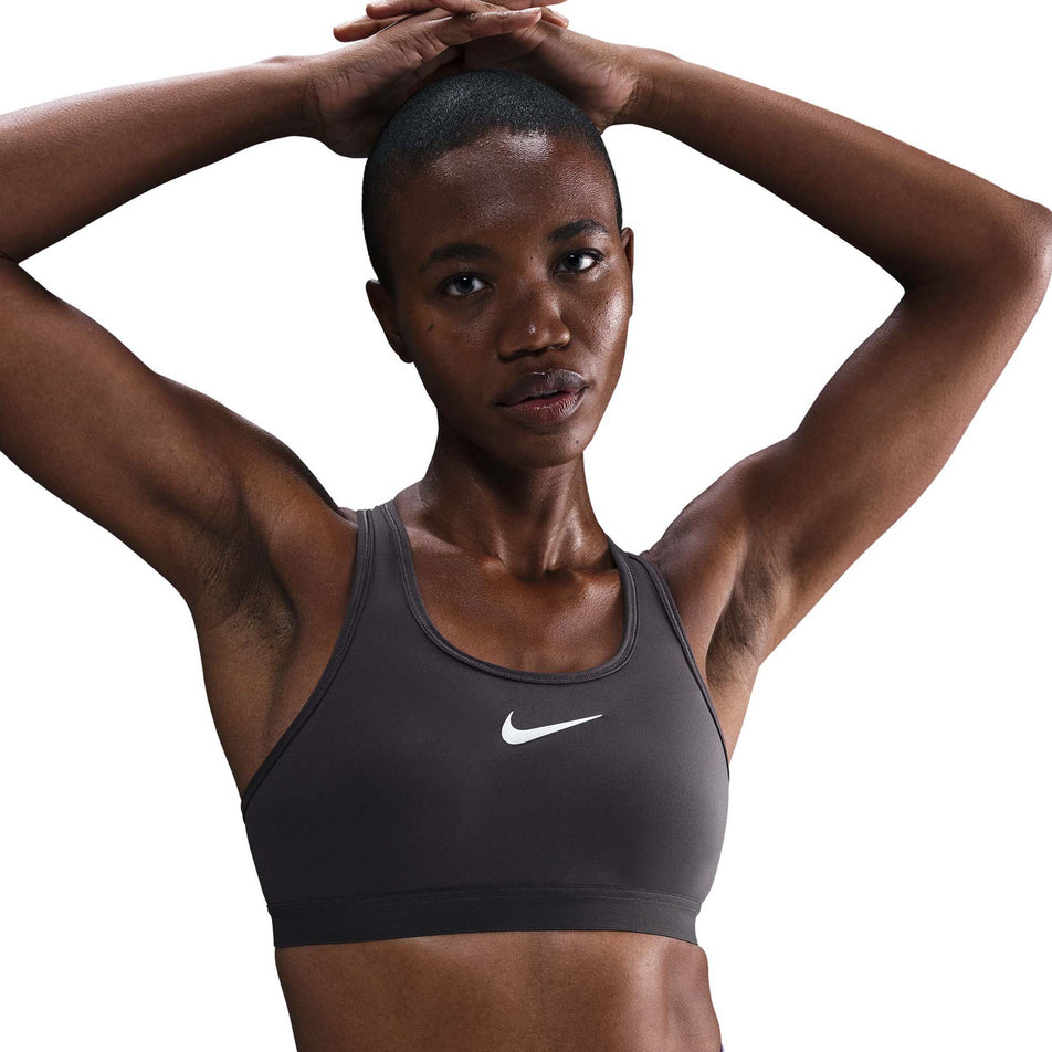 Front view of a model wearing the Nike Women's Swoosh High Support Non-Padded Adjustable Bra in the Thunder Grey colourway. (8692875165858)