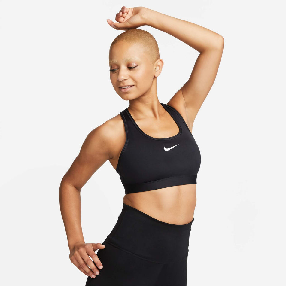 Front view of a model wearing a Nike  Women's Swoosh Medium Support Padded Sports Bra in the Black/White colourway (8140167086242)
