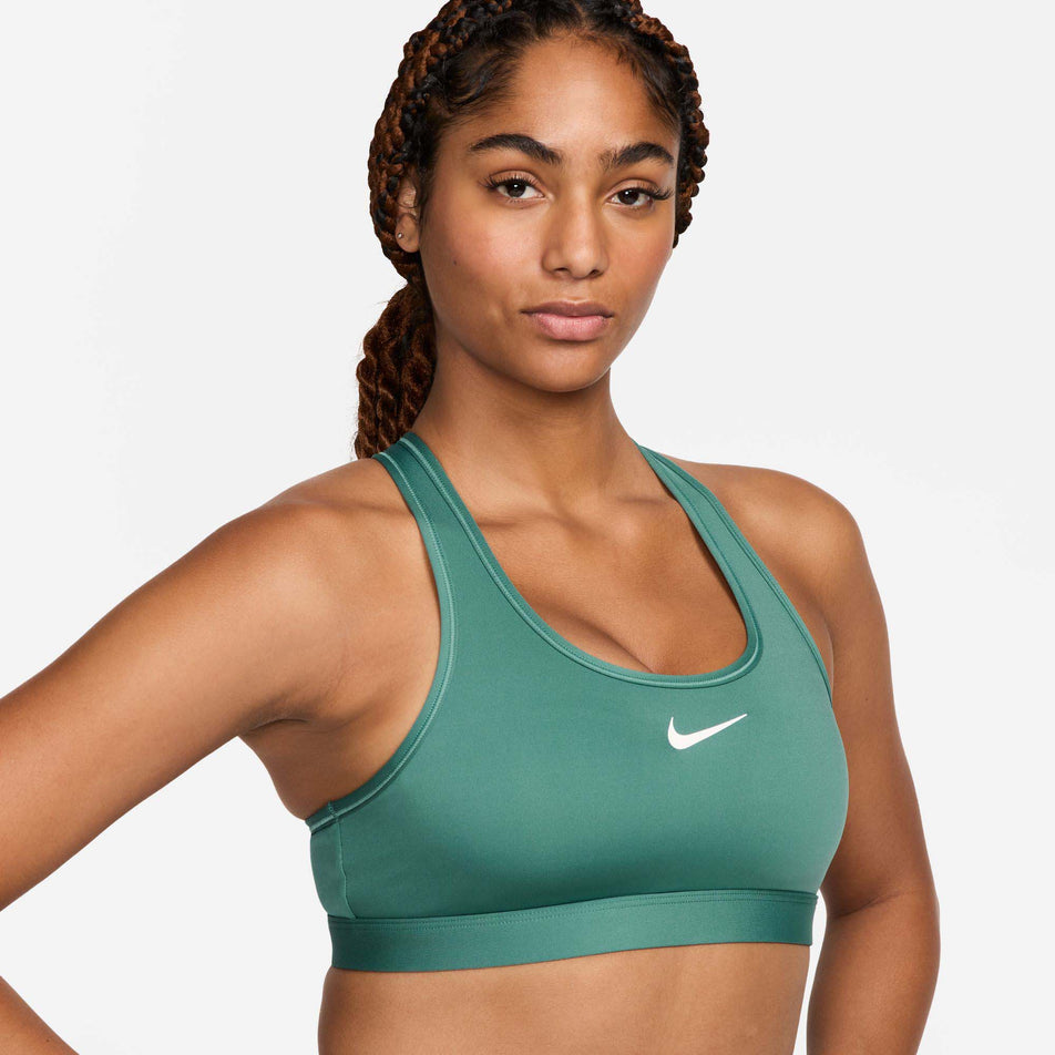 Front view of a model wearing a Nike Women's Swoosh Medium Support Padded Sports Bra in the Bicoastal/White colourway. (8299354063010)