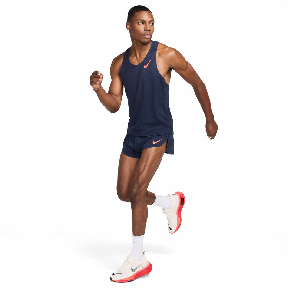 Front view of a model wearing the Nike Men's AeroSwift Dri-FIT ADV Running Singlet in the Obsidian/Bright Crimson colourway. (8574129176738)