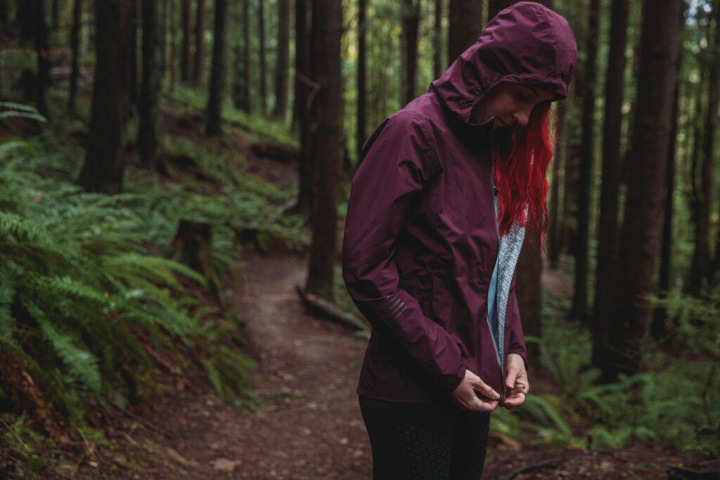 Model zipping up a Salomon Bonatti Jacket