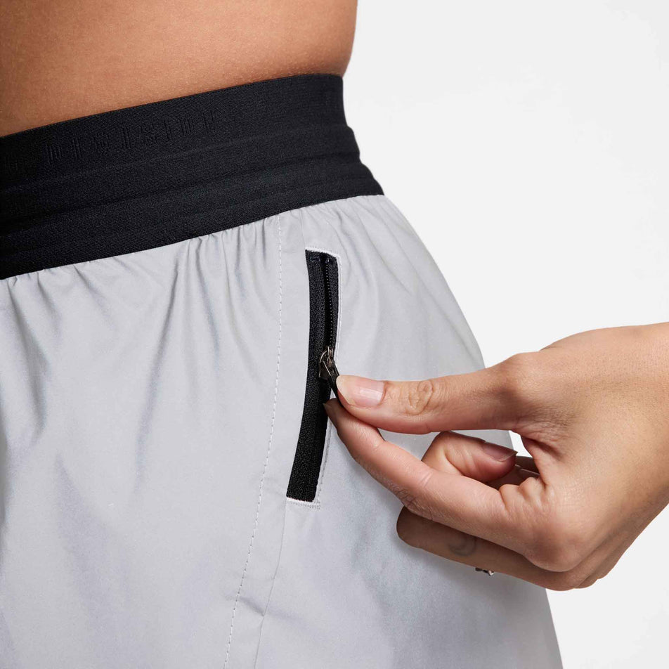 Close-up left-side view of a model wearing a pair of Nike Women's Running Division 3