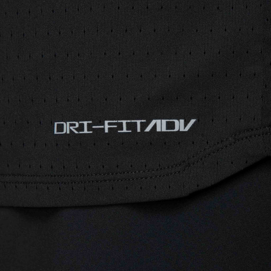 The Nike Dri-FIT ADV branding on the Nike Men's AeroSwift Dri-FIT ADV Short-Sleeve Running Top in the Black/Summit White colourway. (8560399810722)