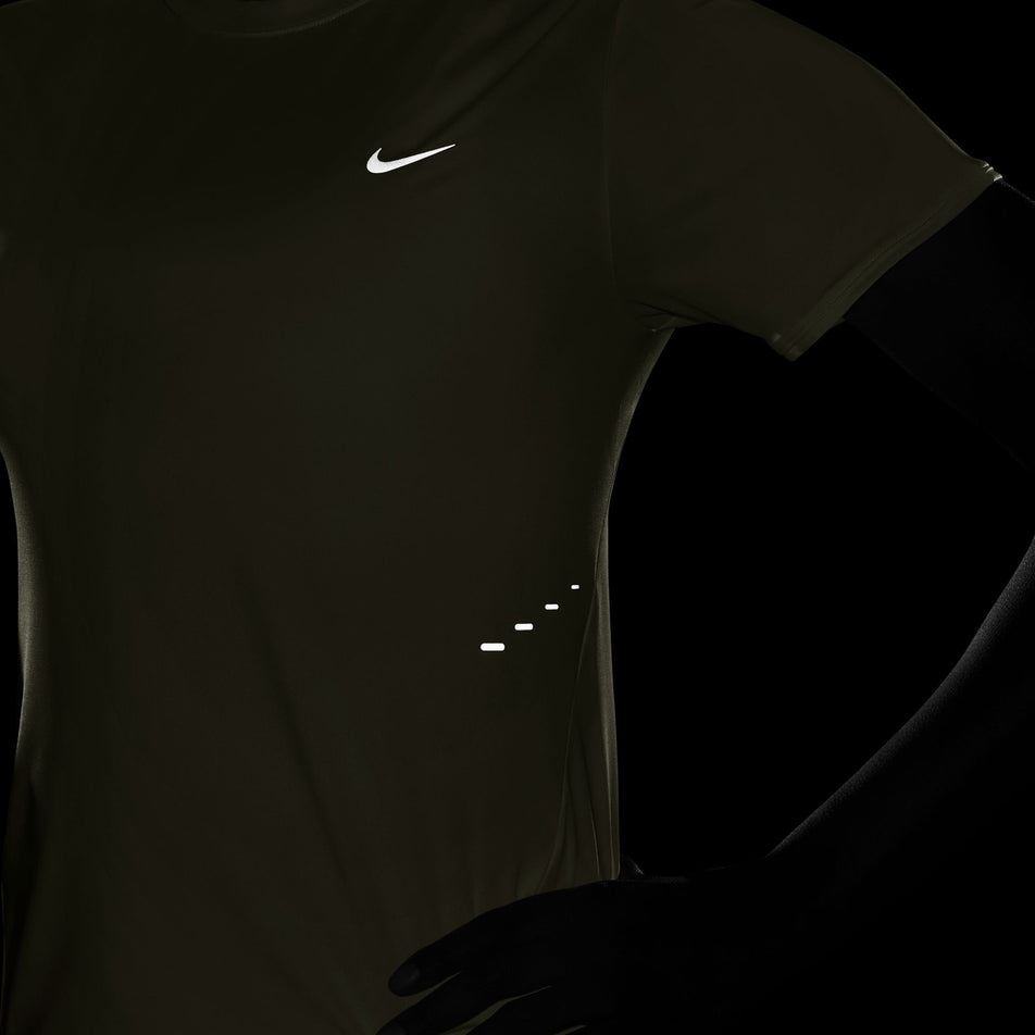 The reflective Nike Swoosh and reflective pills on the Nike Women's Swift Dri-FIT Short-Sleeve Running Top in the Sail/Reflective Silver colourway. (8692848984226)