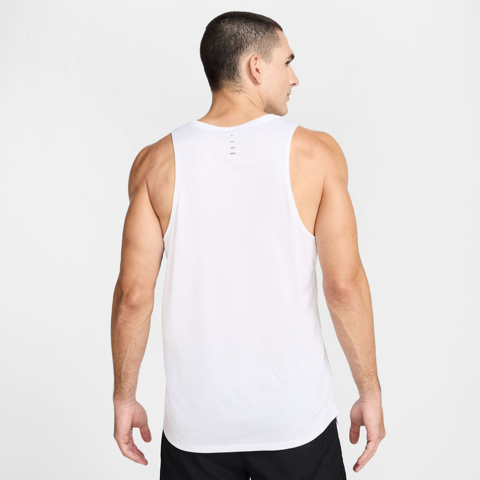 Back view a model wearing the Nike Men's Stride Dri-FIT ADV Running Tank Top in the White/Reflective Silver colourway. (8620702433442)