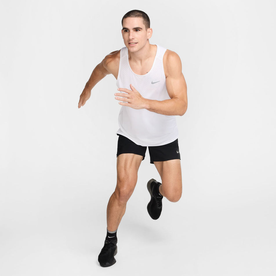 Front view of a model wearing the Nike Men's Stride Dri-FIT ADV Running Tank Top in the White/Reflective Silver colourway. (8620702433442)
