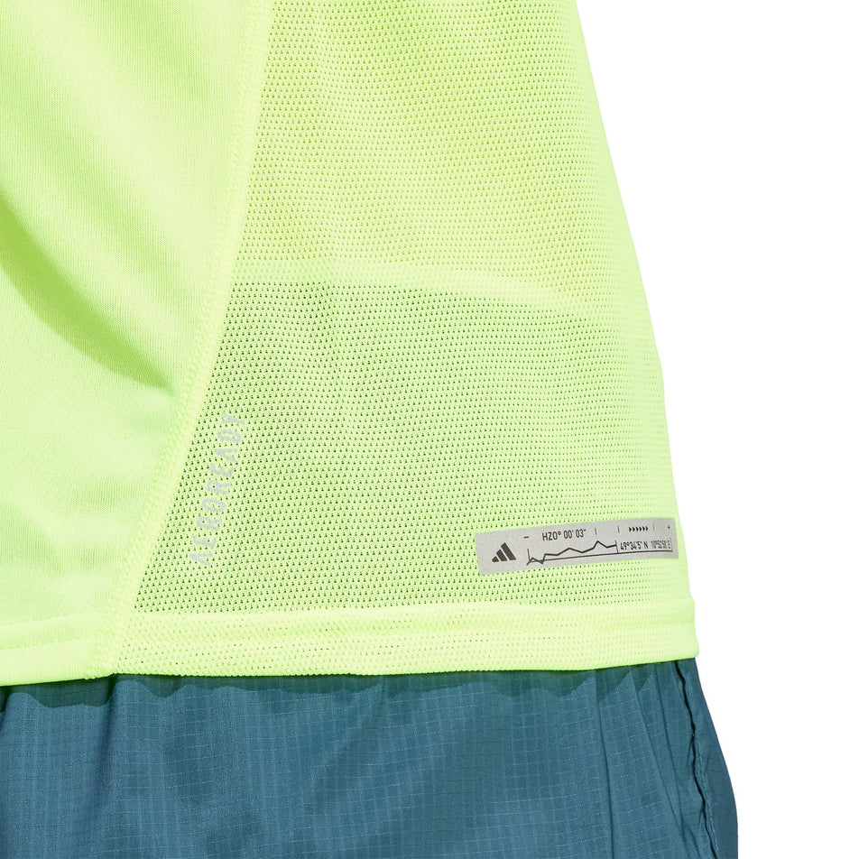 Lower side of an adidas Women's Ultimate Knit T-Shirt in the Lucid Lemon colourway. adidas branding is visible. (8005345771682)