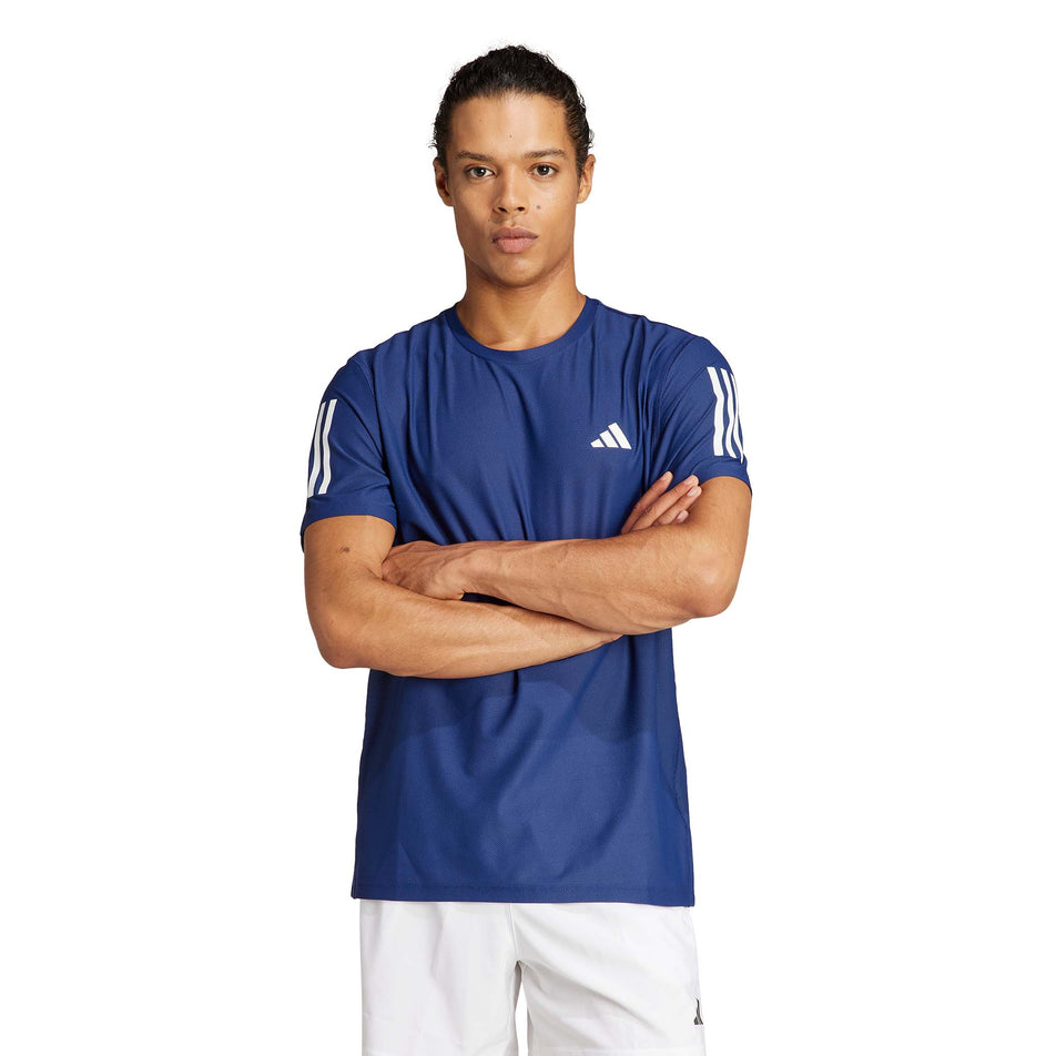 Front view of a model wearing an adidas Men's Own The Run T-Shirt in the Dark Blue colourway. Model is also wearing adidas legwear. (8449482588322)