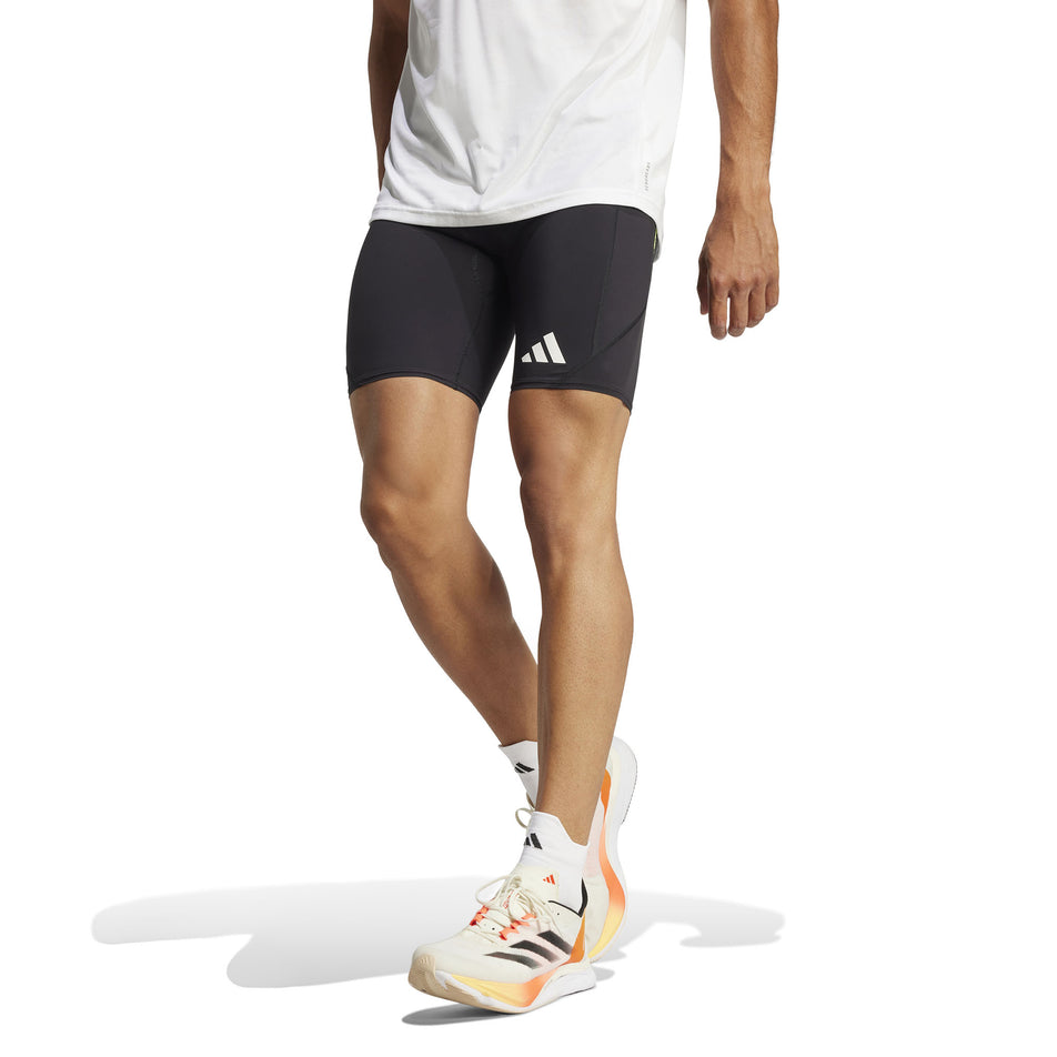 Front view of a model wearing the adidas Men's Adizero Short Tight in the Black colourway. (8566625599650)