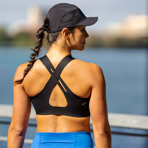 woman standing with crossback bra. 
