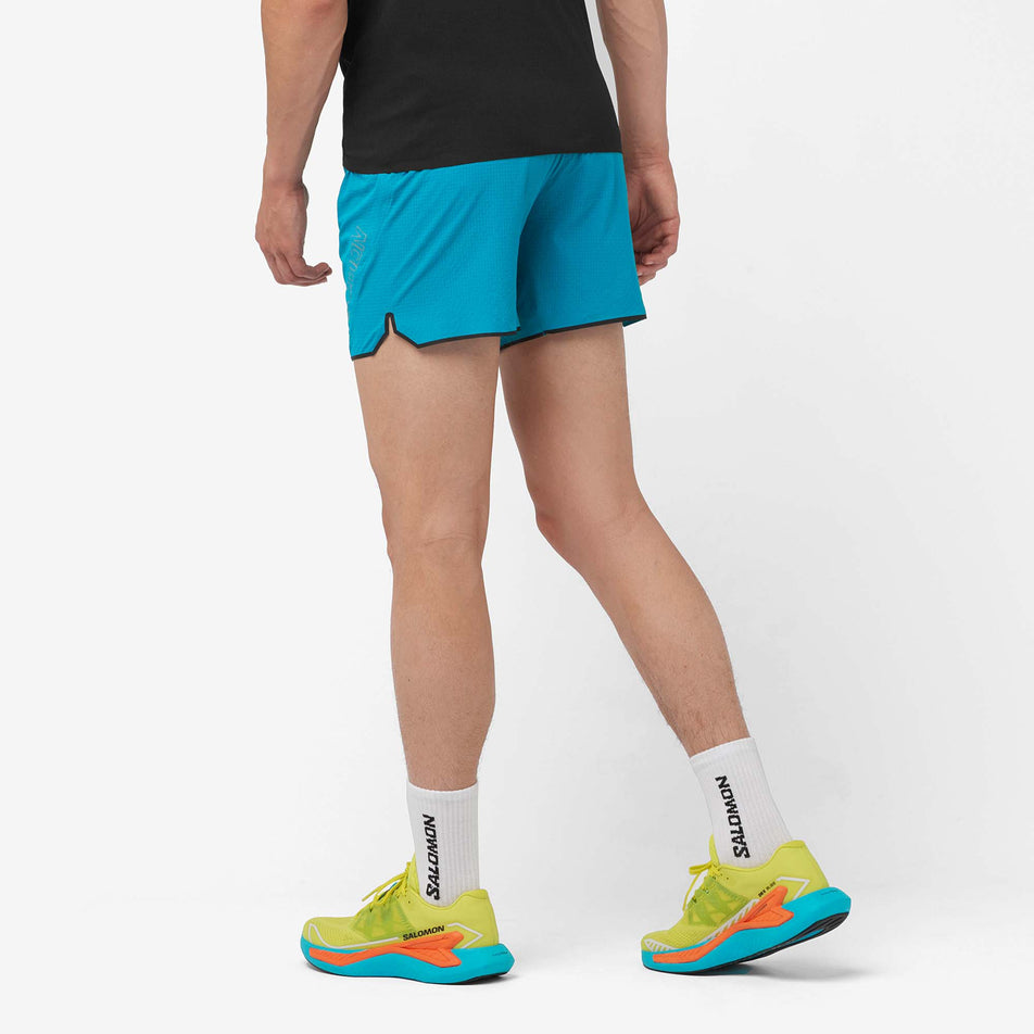 Back view of a model wearing a pair of Salomon Men's Sense Aero 5