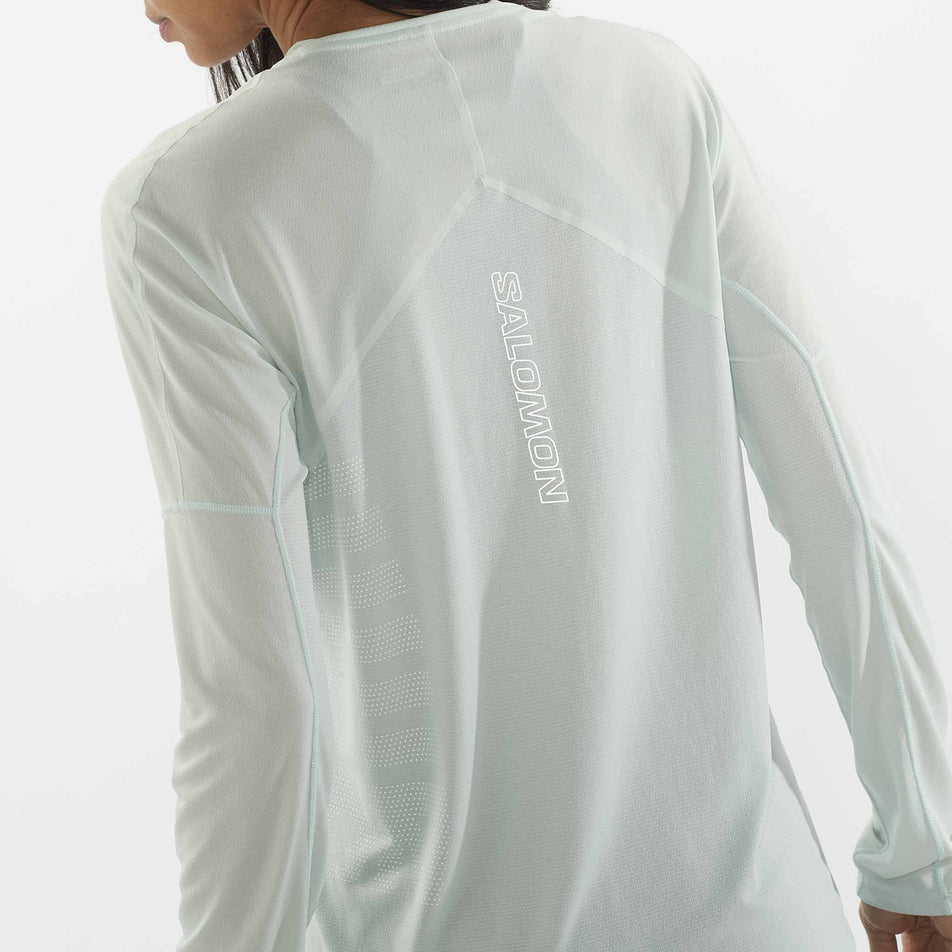 Close-up back view of a Salomon Women's Sense Aero Graphic Long Sleeve T-Shirt in the Misty Blue/White colourway. Top is being worn by a model. (8464072999074)