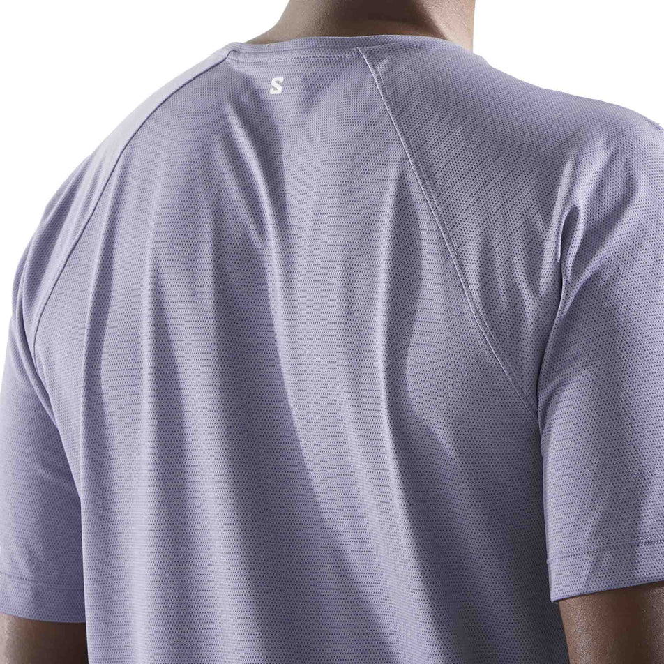 Back view of a model wearing the Salomon Men's SHKout Core Short Sleeve T-Shirt in the Blue Granite colourway. (8575590105250)