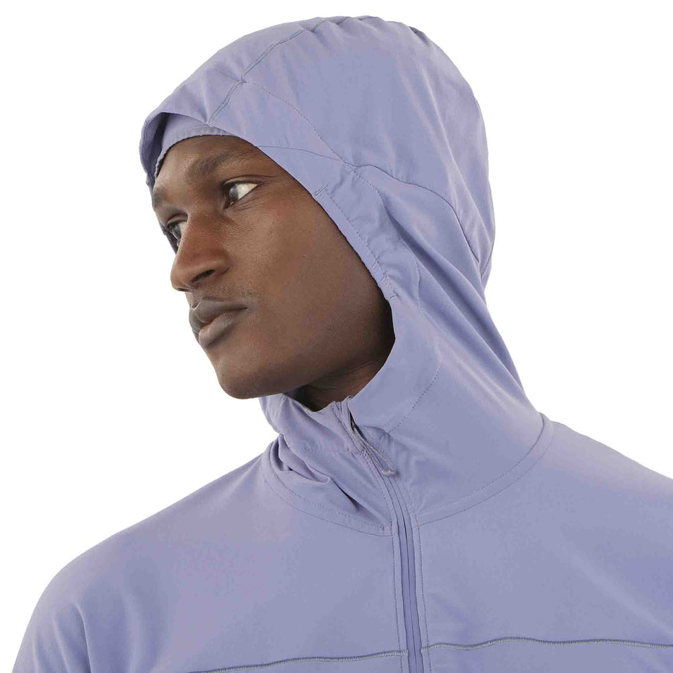 Front view of a model wearing the Salomon Men's Sense Aero Hybrid Midlayer Jacket with Hood in the Blue Granite colourway. (8575574245538)