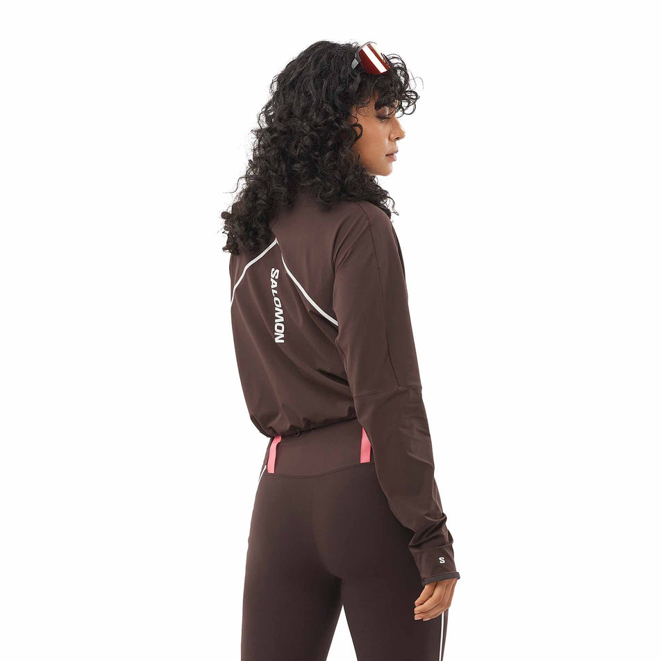 Back view of a model wearing the Salomon Women's Sense Aero Hybrid Cropped Half Zip Midlayer in the Coffee Bean colourway. (8577396867234)