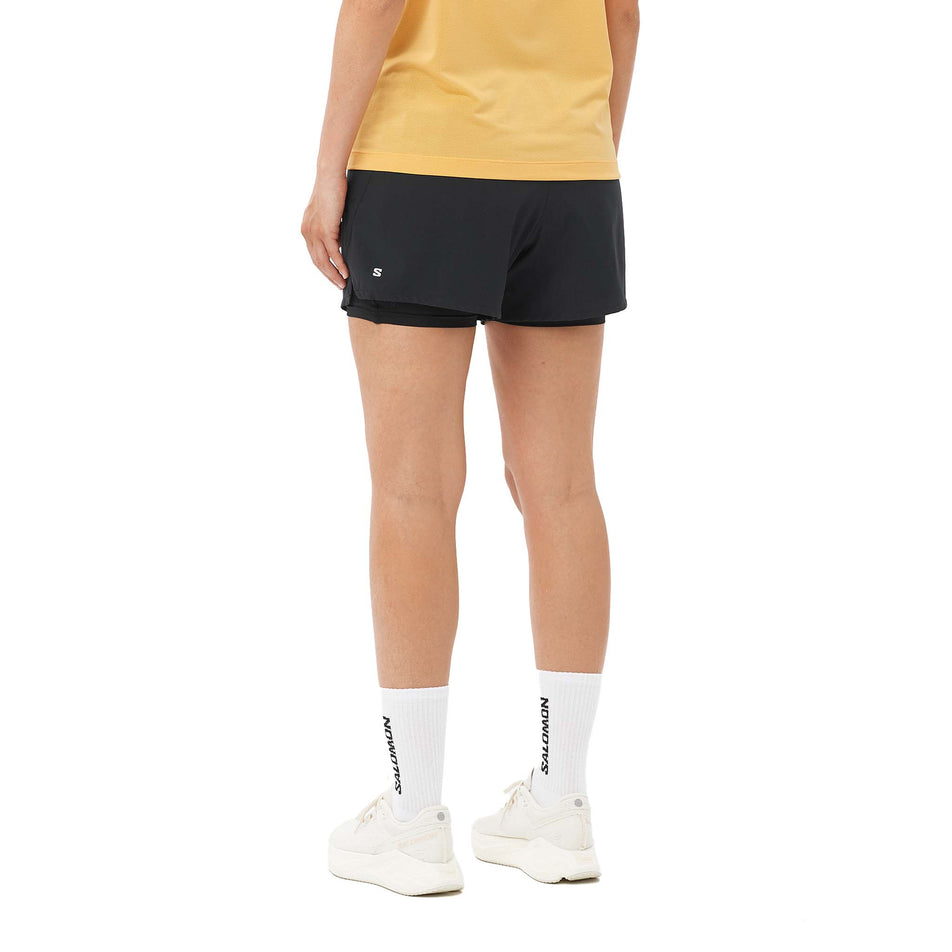 Back view of a model wearing the Salomon Women's SHKout Core 2in1 4