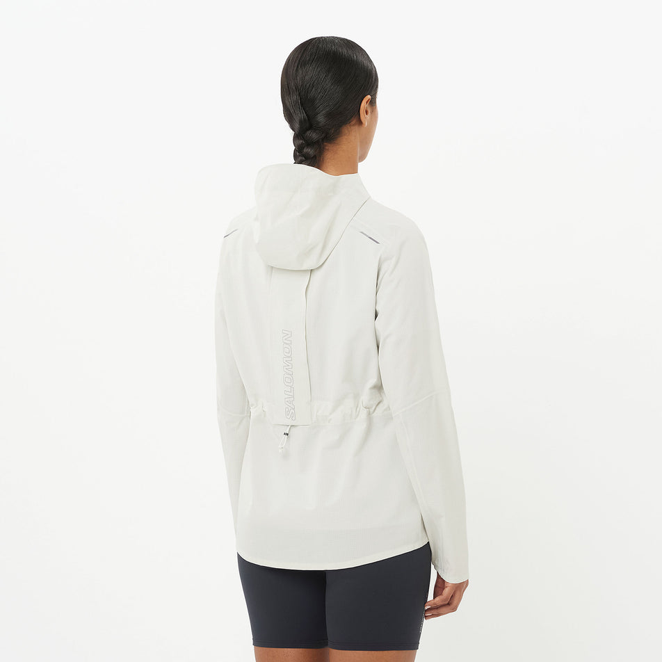 Back view of a model wearing the Salomon Women's Bonatti Trail Shell Jacket in the Icicle colourway. (8576408846498)