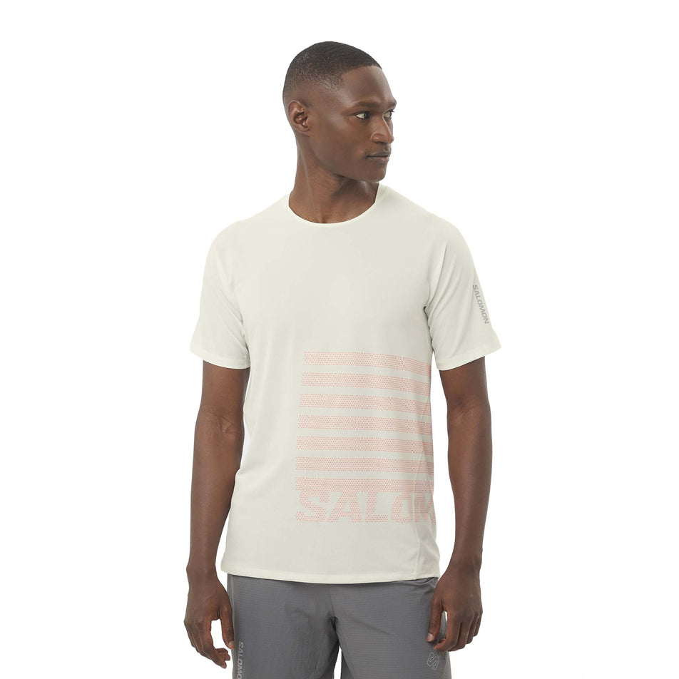 Front view of a model wearing the Salomon Men's Sense Aero Graphic Short Sleeve T-Shirt in the Icicle/Neon Flame colourway. (8575560482978)