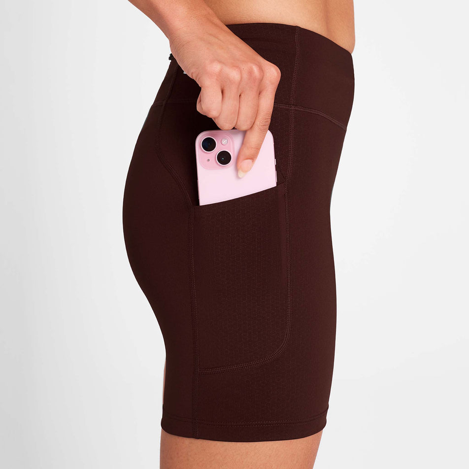 A model demonstrating the drop-in pocket on the side of the SAYSKY Women's Combat+ Short Tights 7