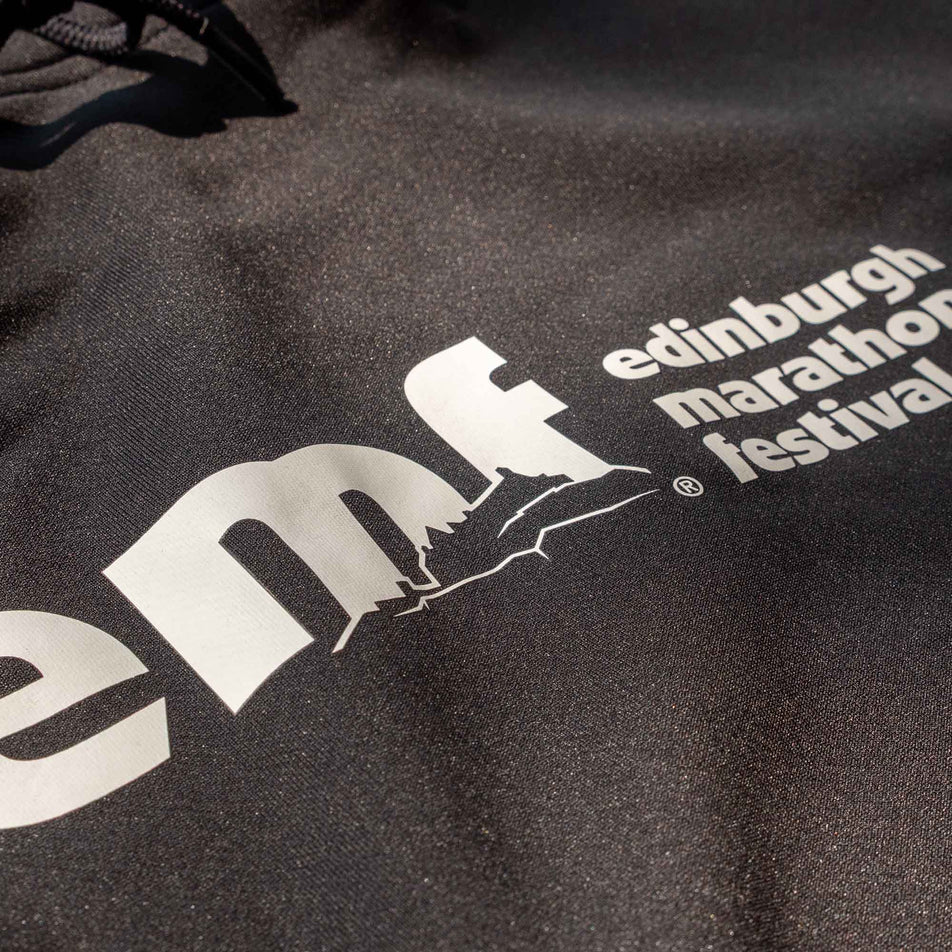 Close-up of the EMF logo on the front of a Pressio Men's Hoodie from the range of EMF Official Licensed Merchandise (8331733696674)