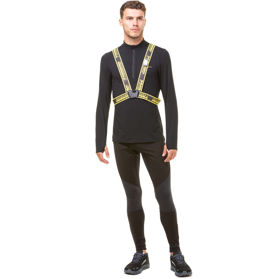 Front view of a model wearing a Ronhill Reflective Belt in the Fluo Yellow/Reflect colourway. Model is also wearing a Ronhill running top, Ronhill running tights and Altra running shoes. (8048565420194)