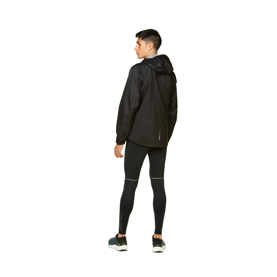 Back view of a model wearing the Ronhill Men's Tech Fortify Jacket in the All Black colourway. Model is also wearing shoes and a top. (8490250829986)