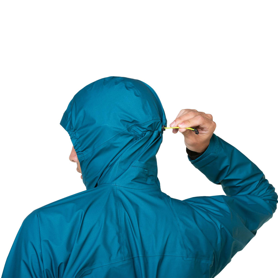 A model demonstrating the adjustment cord on the back of the hood of a Ronhill Men's Tech GORE-TEX Mercurial Jacket. The jacket is being worn by the model. (8470598418594)