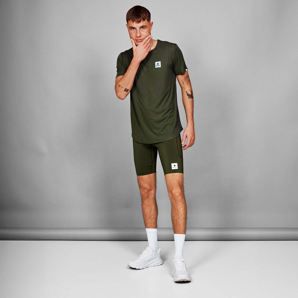 Front view of a model wearing a SAYSKY Men's Clean Flow T-Shirt in the Green colourway. Model is also wearing shorts, socks and shoes. (8628464976034)